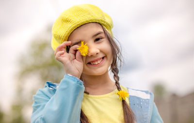 Portrait of young woman holding flower