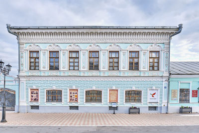 Low angle view of building against cloudy sky