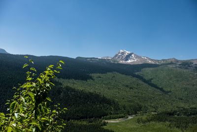 Scenic view of mountains against clear blue sky