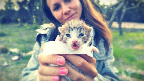 Portrait of woman holding puppy