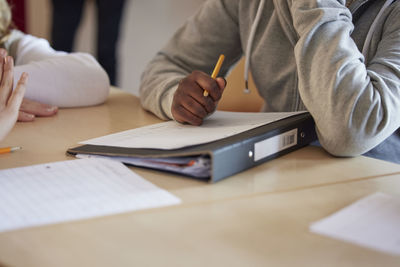 Student taking notes in class