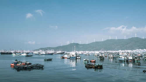 Sailboats in sea against sky