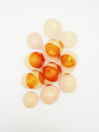 Close-up of eggs over white background