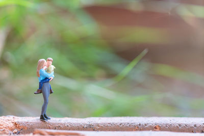 Close-up of stuffed toy on retaining wall