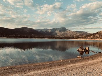 Scenic view of lake against cloudy sky