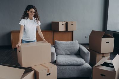 Young woman sitting on sofa at home