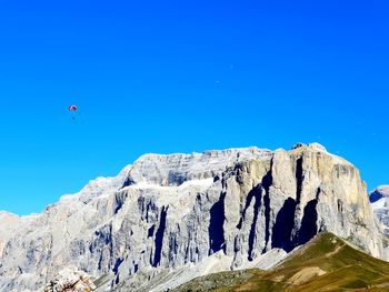 Scenic view of rocky mountain against clear blue sky