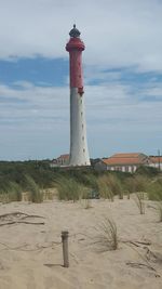 Lighthouse against cloudy sky