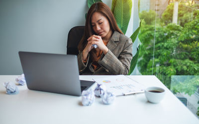 Young woman using laptop on table