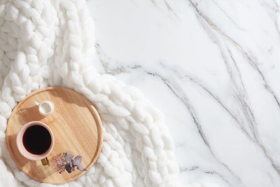 High angle view of coffee cup on bed