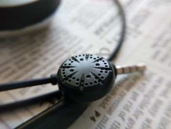 High angle view of text on book with earphone