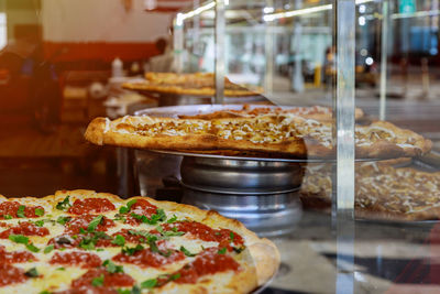 Close-up of pizza in kitchen at restaurant