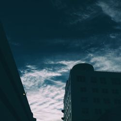 Low angle view of building against cloudy sky