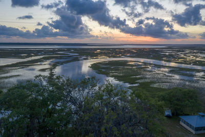 Scenic view of beach against sky during sunset