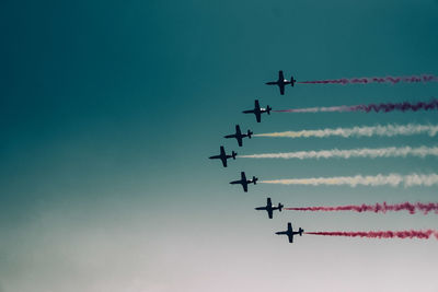 Low angle view of airshow against sky