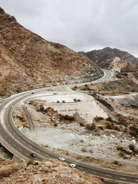 High angle view of road by mountain against sky