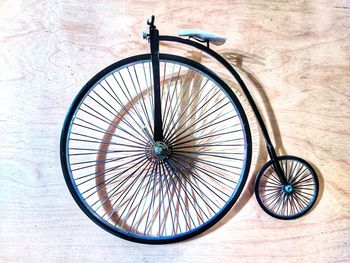 High angle view of bicycle wheel on wood