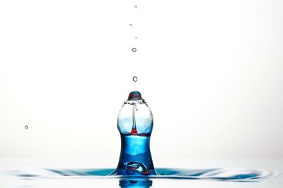 Close-up of water splashing against white background