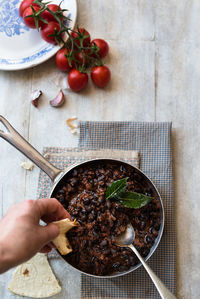 Cropped hand having food on table