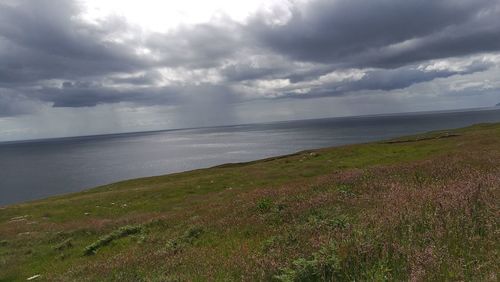 Scenic view of sea against storm clouds