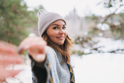 Portrait of smiling young woman standing outdoors