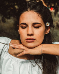 Portrait of a beautiful young woman with eyes closed