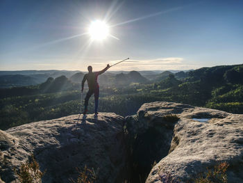 Man with crutches and strong will. disabled tourist successfully climb in park. hiker attach target