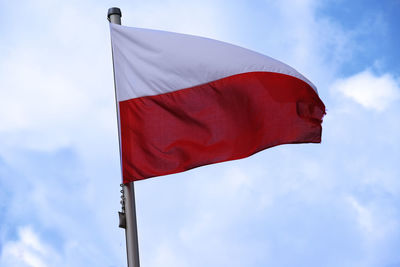 Low angle view of polish flag against sky