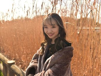 Portrait of smiling woman standing in winter