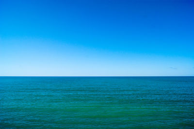 Scenic view of sea against clear blue sky