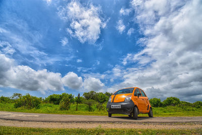 Car on field against sky