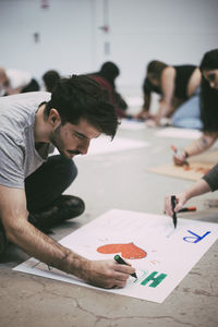 Young man preparing signboard to protest against equal rights