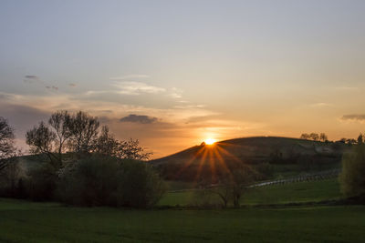 Scenic view of field against sky during sunset