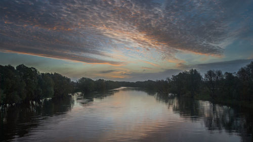 Scenic view of lake against sky during sunset