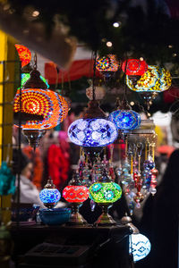 Close-up of illuminated lanterns hanging at night