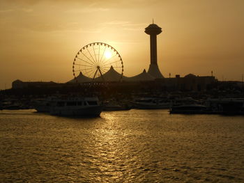 Ferris wheel in city at sunset