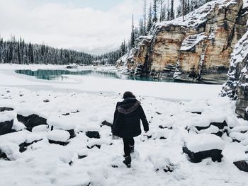 Rear view of woman on snow covered land