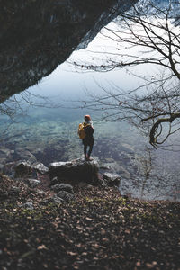 Full length of woman standing on rock at konigssee - bavaria