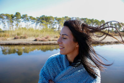 Portrait of smiling young woman looking away