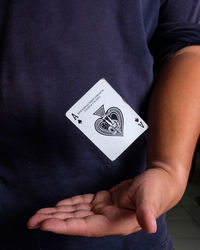 Midsection of man playing poker