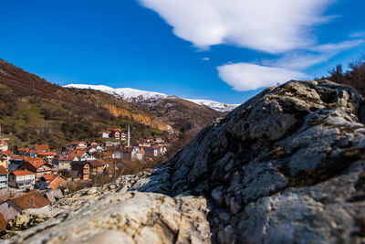 Houses on mountain against blue sky