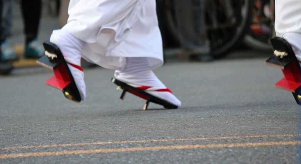 LOW SECTION OF PEOPLE WALKING ON ZEBRA CROSSING