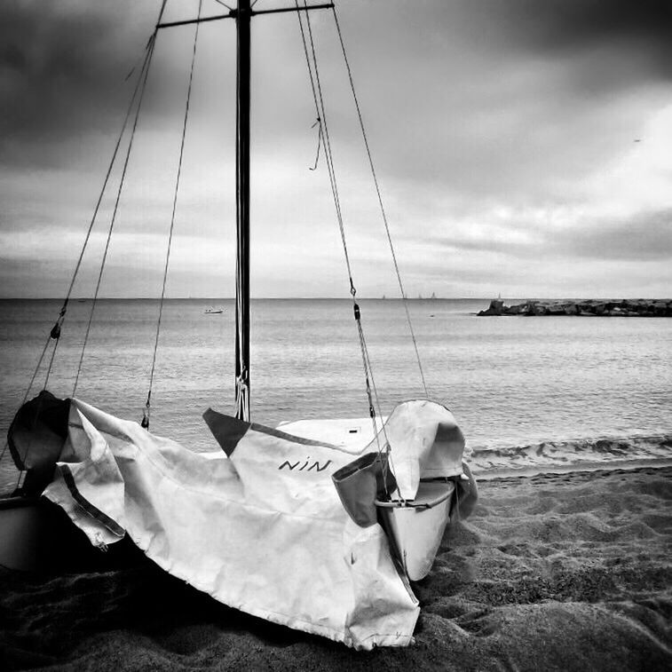 sea, sky, water, beach, nautical vessel, horizon over water, boat, shore, tranquility, tranquil scene, transportation, sand, moored, cloud - sky, scenics, beauty in nature, cloud, nature, cloudy, mode of transport