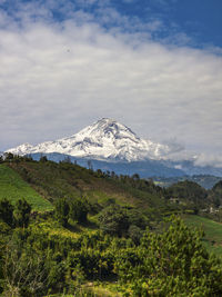 Scenic view of mountains against cloudy sky