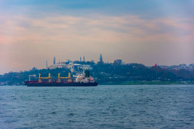 Scenic view of sea and buildings against sky