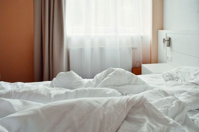 Crumpled blanket on bed in bedroom