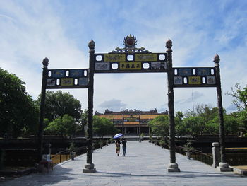 People walking on street against sky