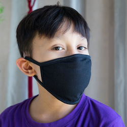 Close-up portrait of boy wearing mask