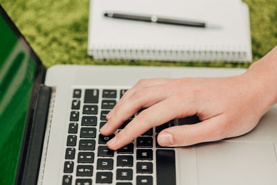 Cropped hands using laptop