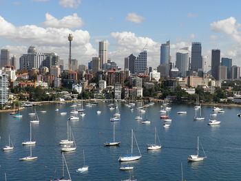 View of boats in city at waterfront